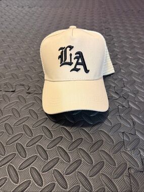 LA Embroidered Trucker Hat in Cream with Black Logo